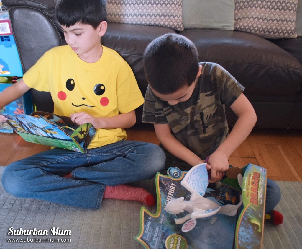Boys opening How to Train Your Dragon toys