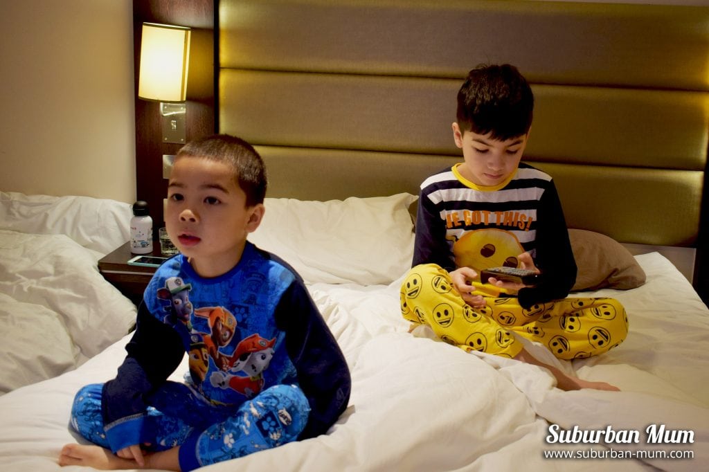 Boys watching tv in bed with The Pyjama Factory pyjamas