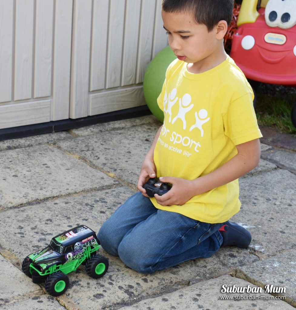 M playing with the Monster Jam Grave Digger remote control car