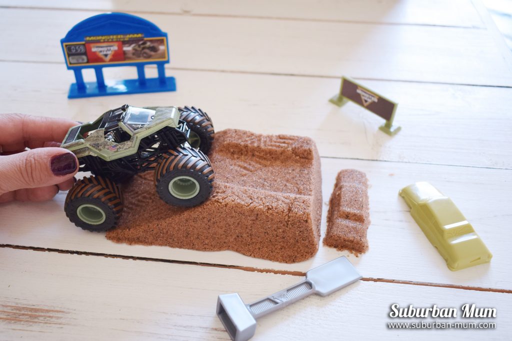 Monster Jam Monster Dirt Deluxe set with monster truck going up a rampe and kinetic sand