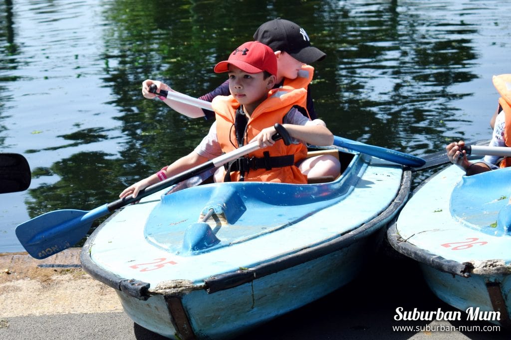 Child rowing in a canoe at Wicksteed Park