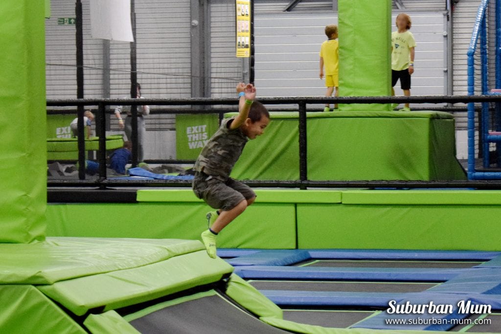 M, mid-air jumping off a trampoline