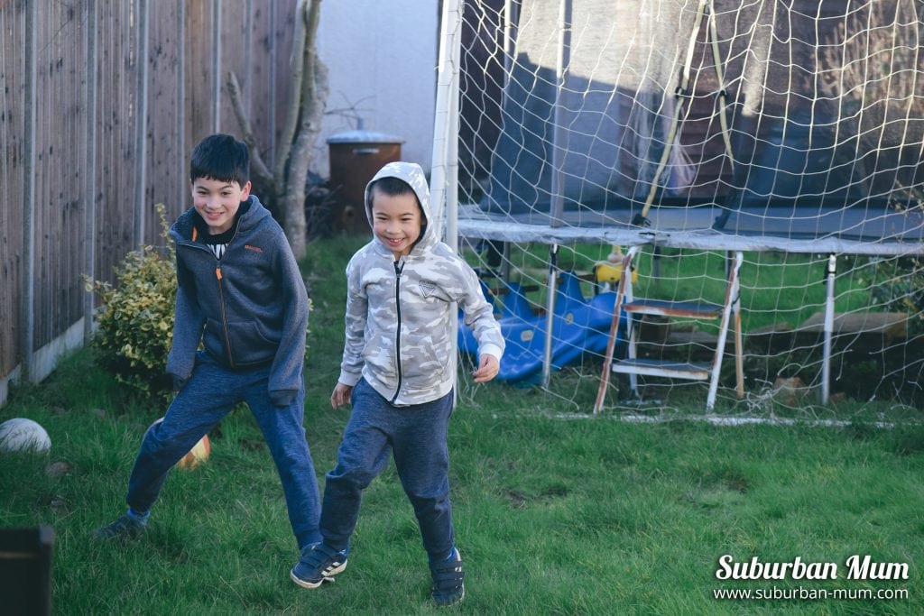 boys-playing-football-garden