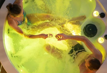 couple in garden hot tub