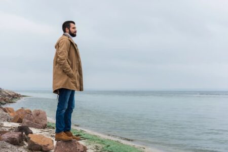 man outside with coat