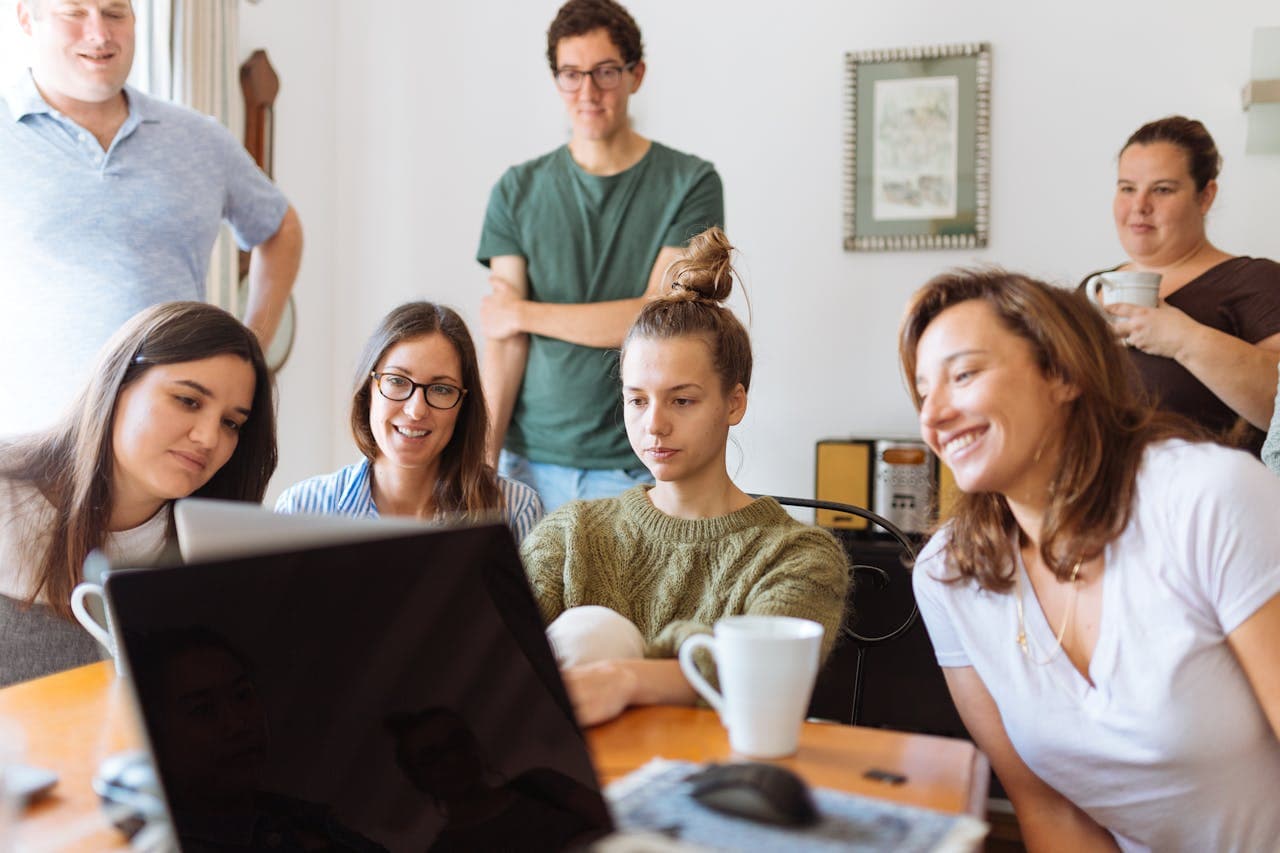 people looking at laptop