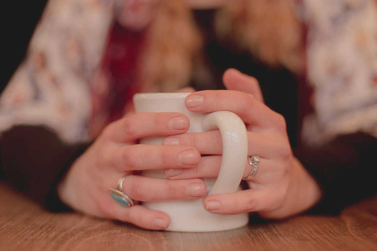 woman holding cup of tea