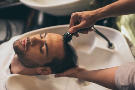 man having hair washed