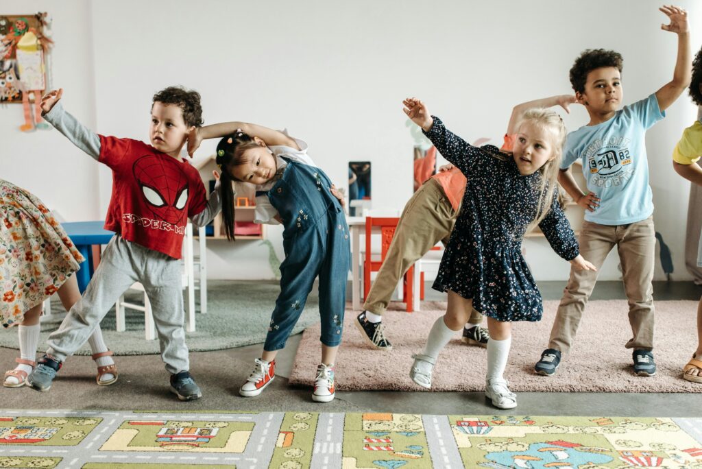 group of young children doing fun indoor exercise activities in a school setting