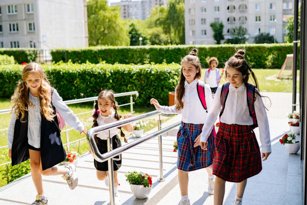 pexels-yankrukov-8617515 Schoolgirls in uniform walking together outdoors on their way to school