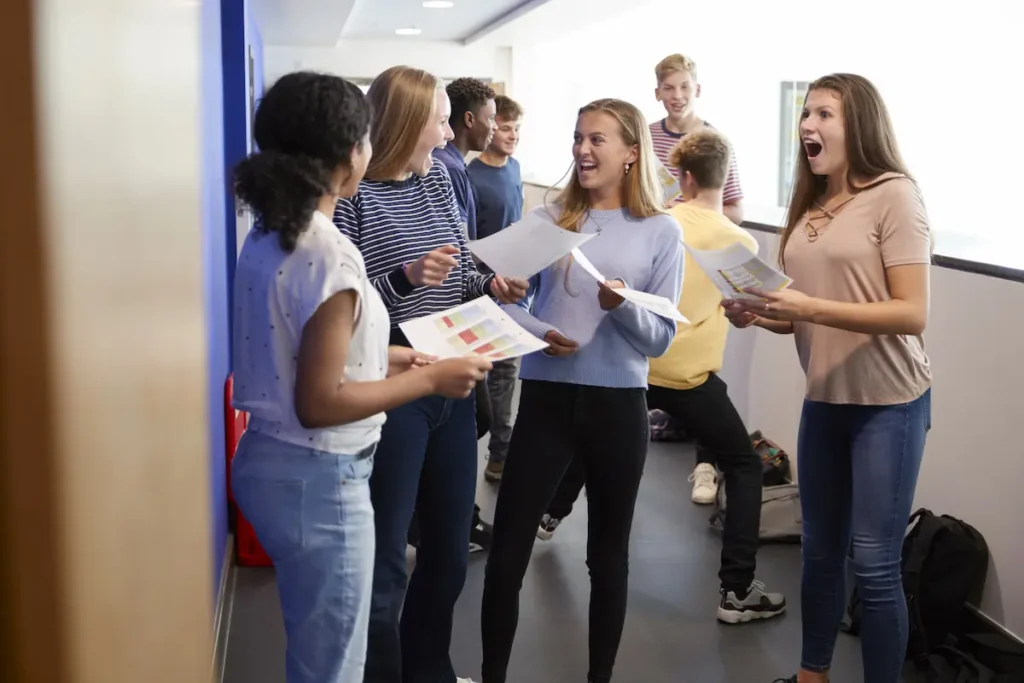 Teenager opening GCSE results envelope on results day