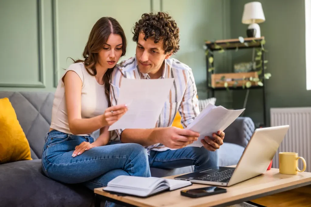 Couple reviewing financial documents together at home
