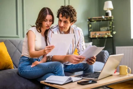 Couple reviewing financial documents together at home