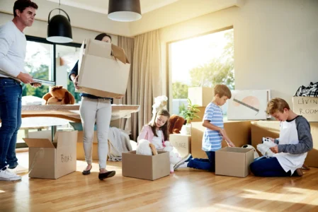 Family unpacking boxes after moving into a larger home