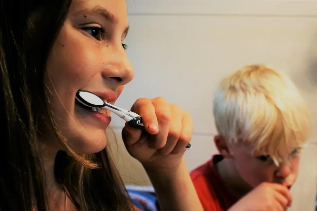 Children brushing their teeth at home