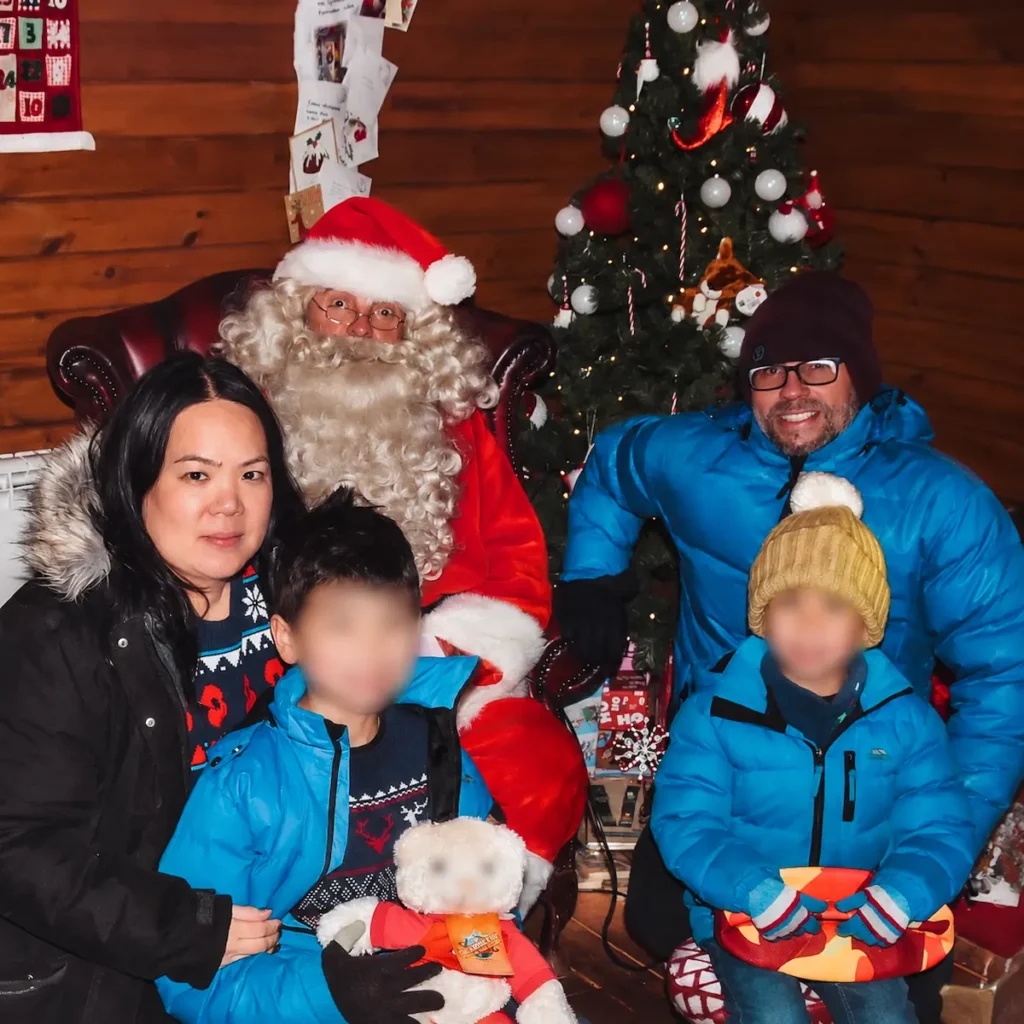 Family meeting Father Christmas at a festive grotto
